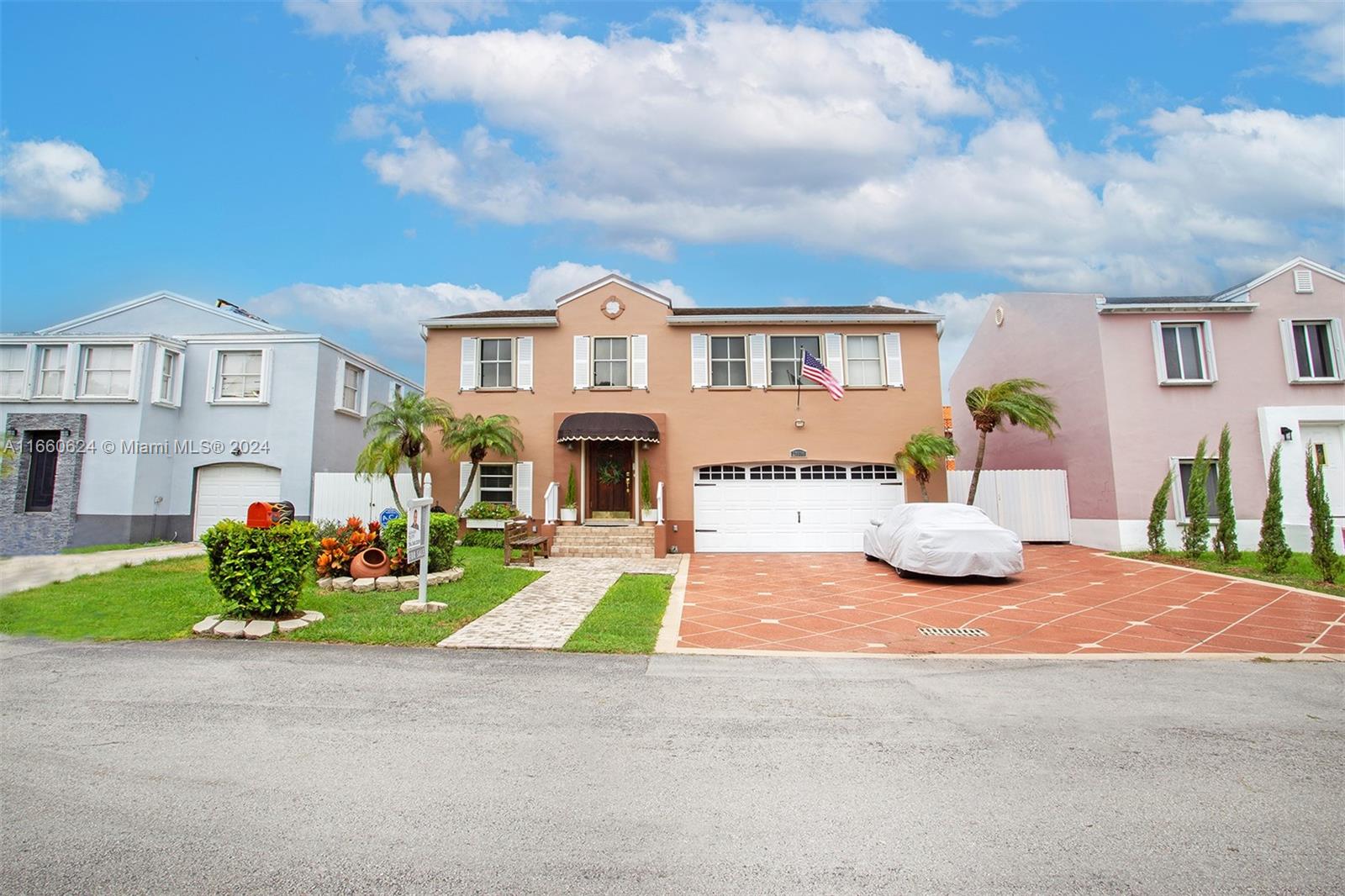 a front view of a house with a yard and garage