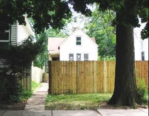 a view of a house with a yard and potted plants