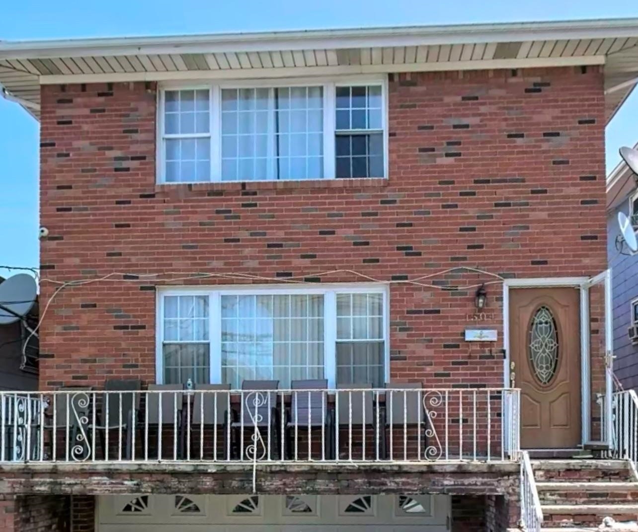 a front view of a house with a fence