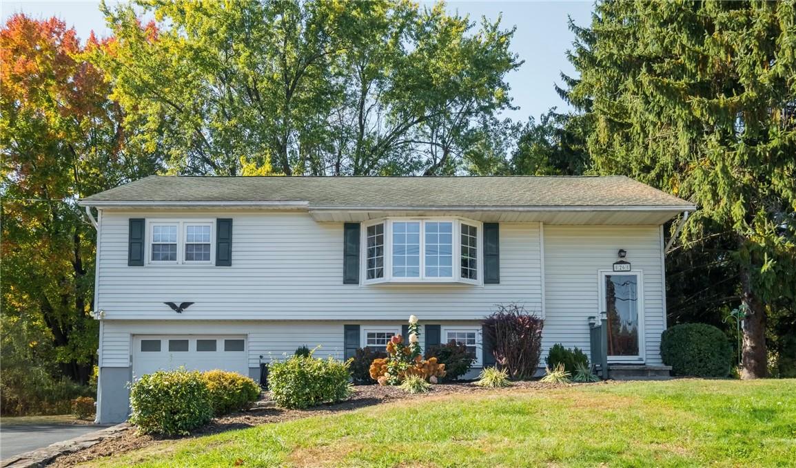 Bi-level home featuring a front yard and a garage