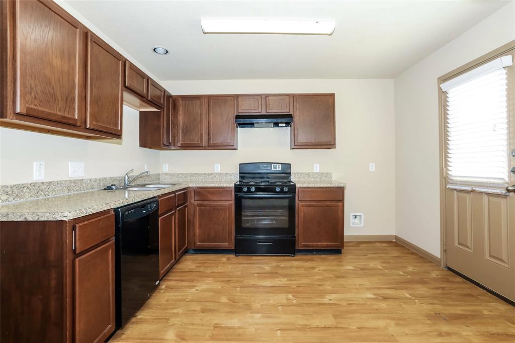 a kitchen with stainless steel appliances granite countertop a stove and a sink