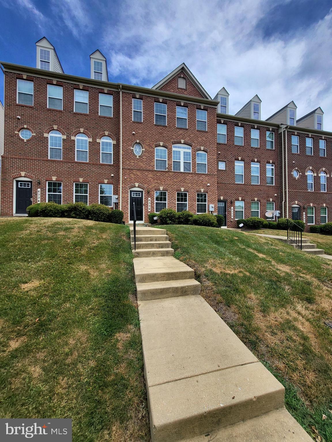 a view of a big yard in front of a brick building