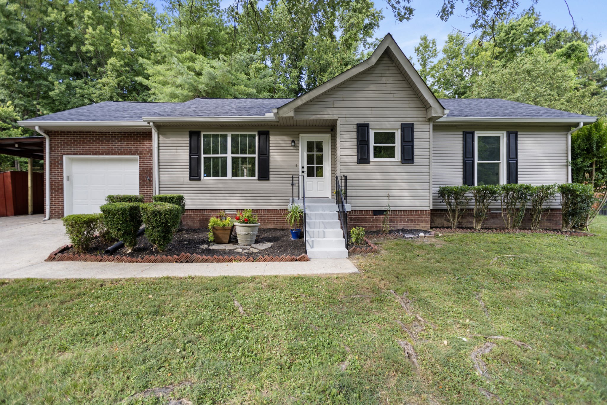 a front view of house with yard and outdoor seating