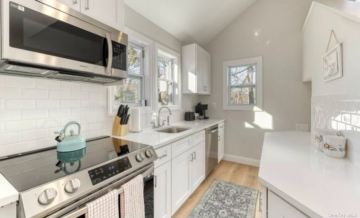 a kitchen with a sink and a stove top oven