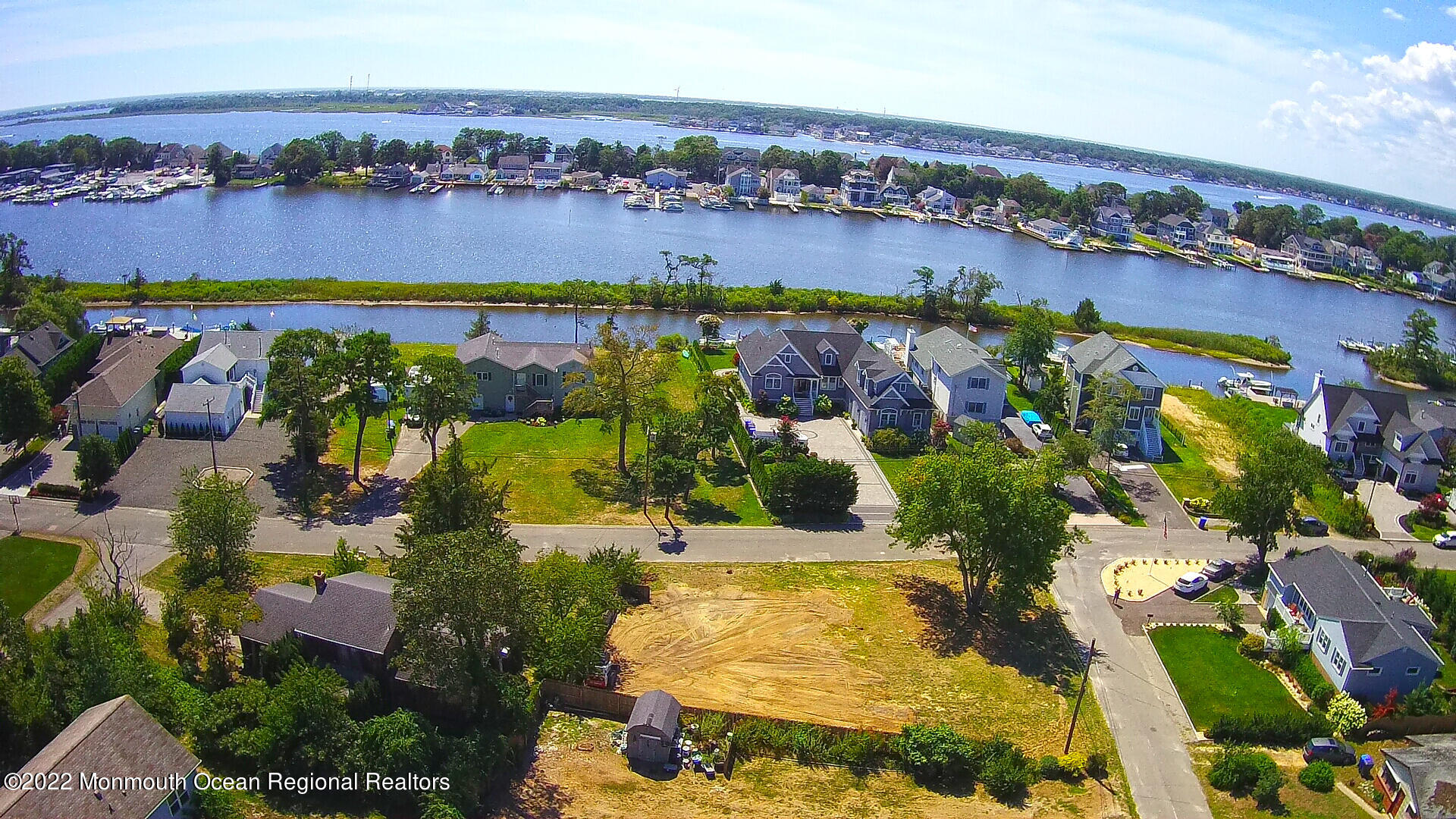 an aerial view of lake and residential houses with outdoor space