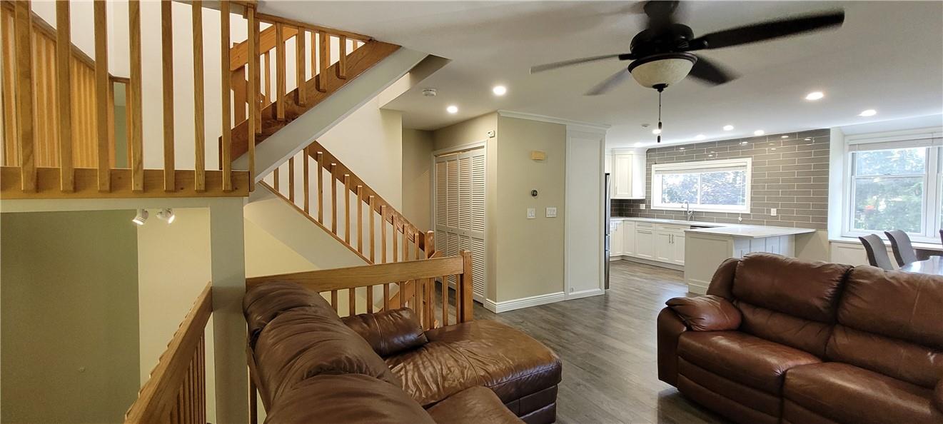 a living room with furniture with a ceiling fan