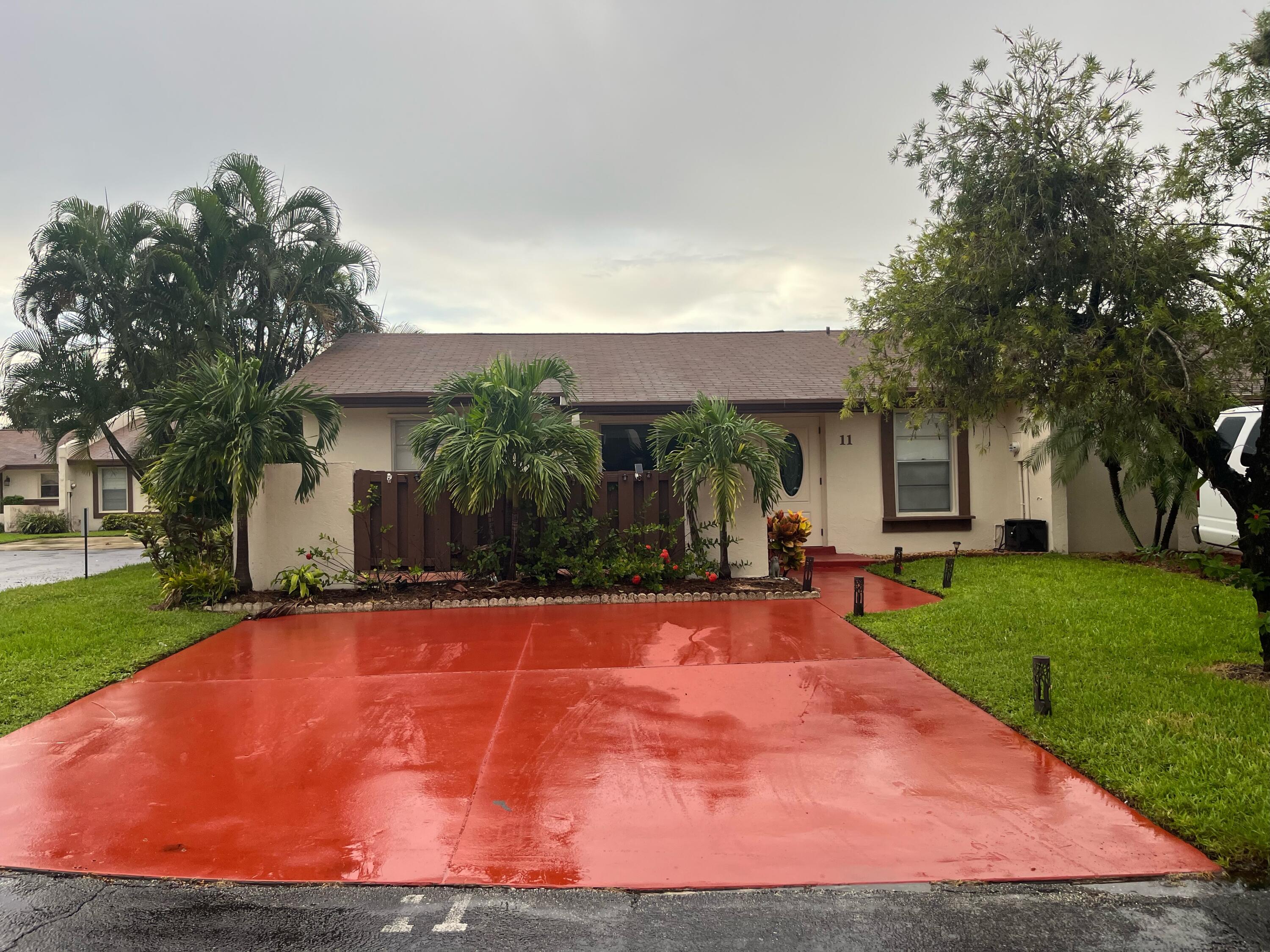 a view of a house with a yard and tree s