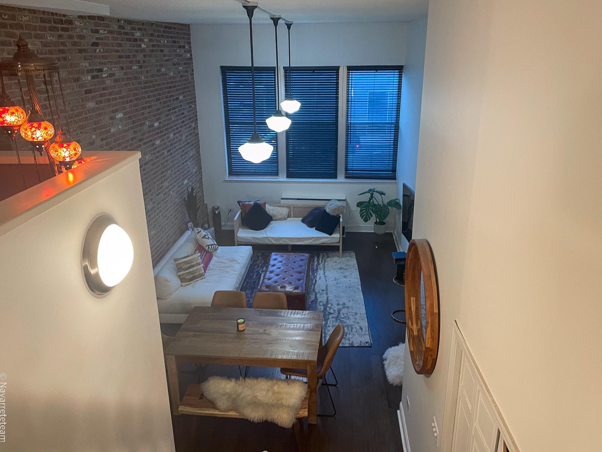 Dining room featuring hardwood / wood-style flooring and brick wall