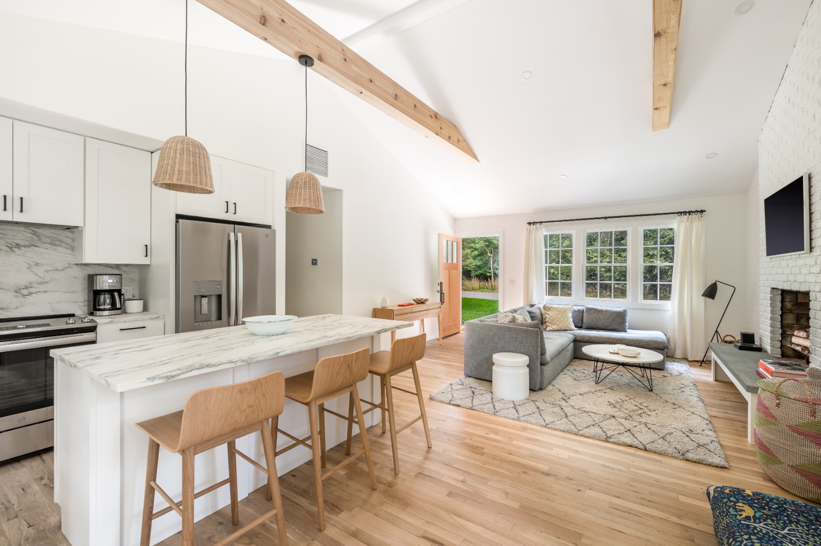 a living room with furniture a window and kitchen view