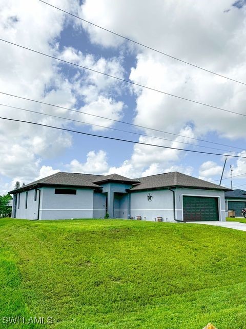 a view of house with yard in front of it