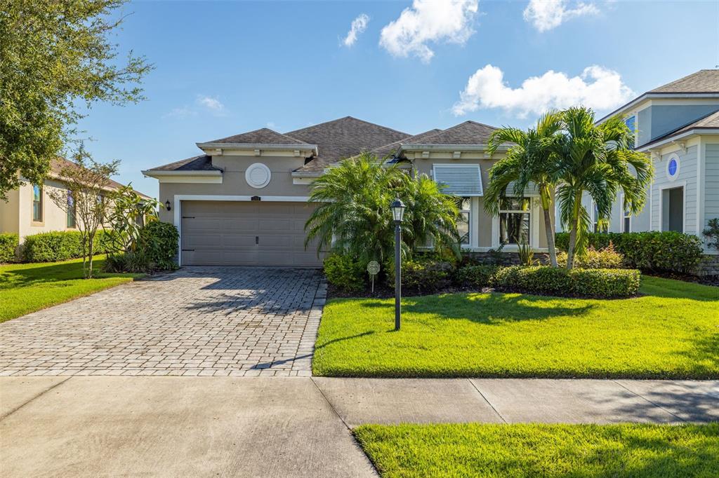 a front view of a house with a yard and garage