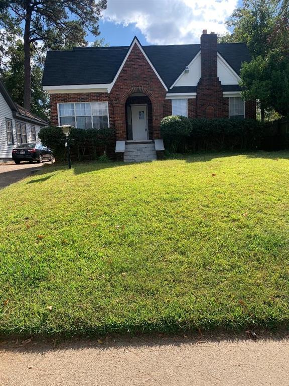 a front view of a house with yard and garage