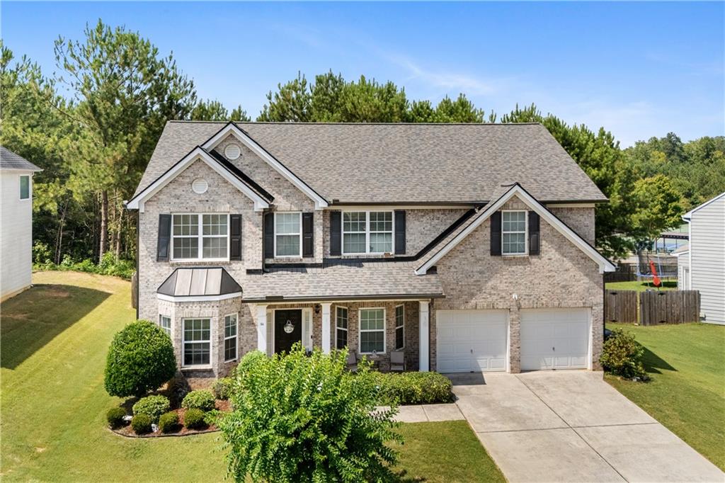 a aerial view of a house next to a yard