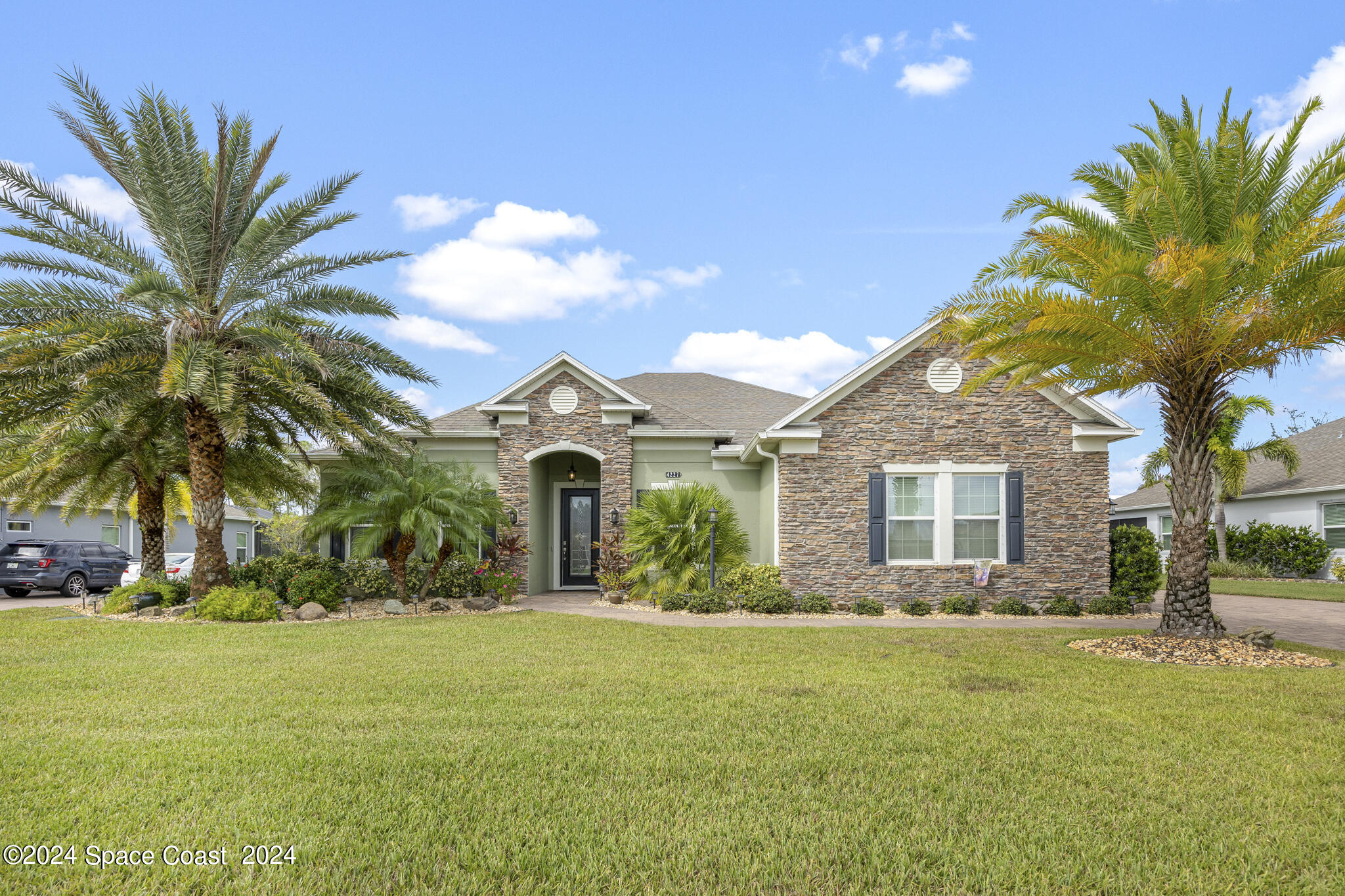 a front view of house with yard and green space