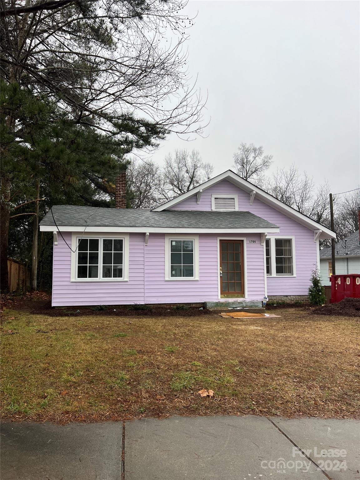 a front view of house with yard and trees