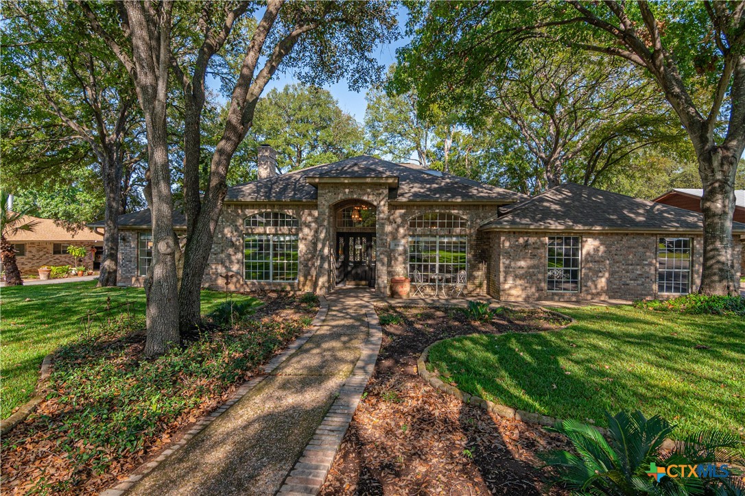 a front view of a house with garden