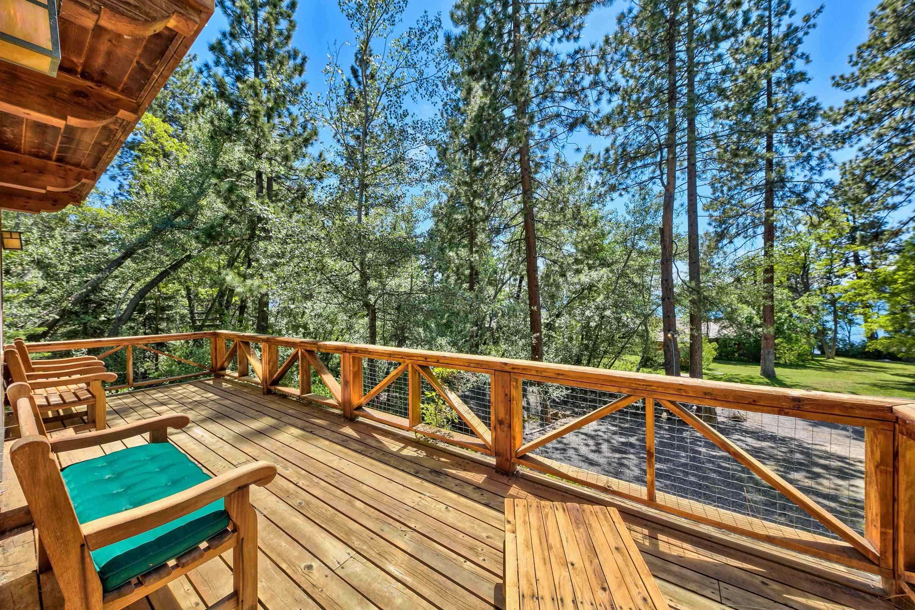 a view of a balcony with wooden floor and outdoor space