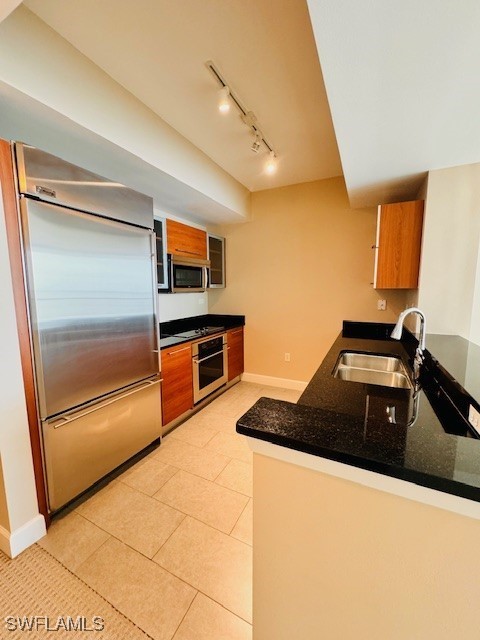 a kitchen with granite countertop a refrigerator and a stove