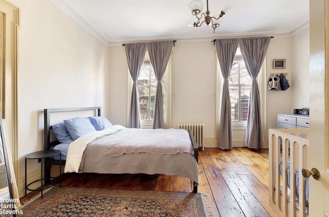 a bedroom with a bed dresser and a window