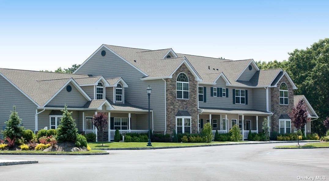 front view of a brick house with a yard