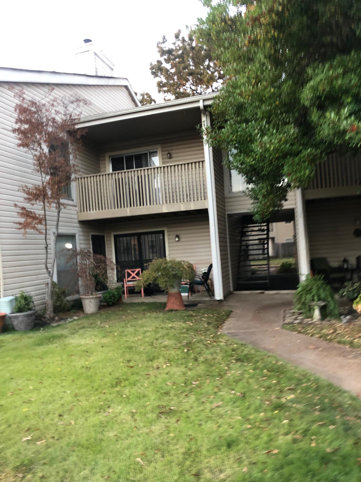 a view of a house with a patio and a yard