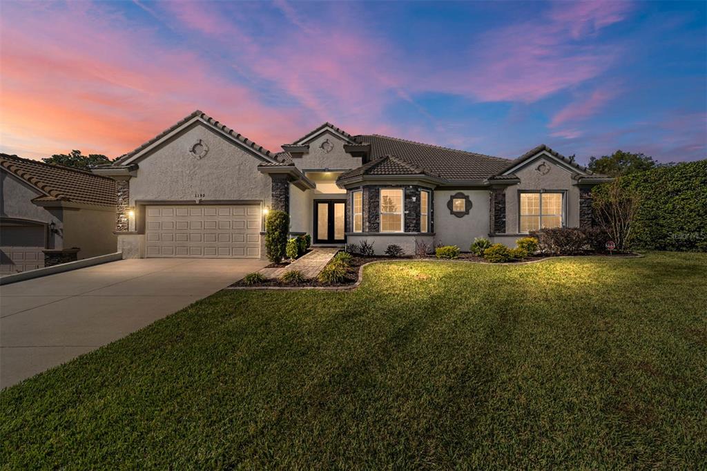 a front view of a house with a yard