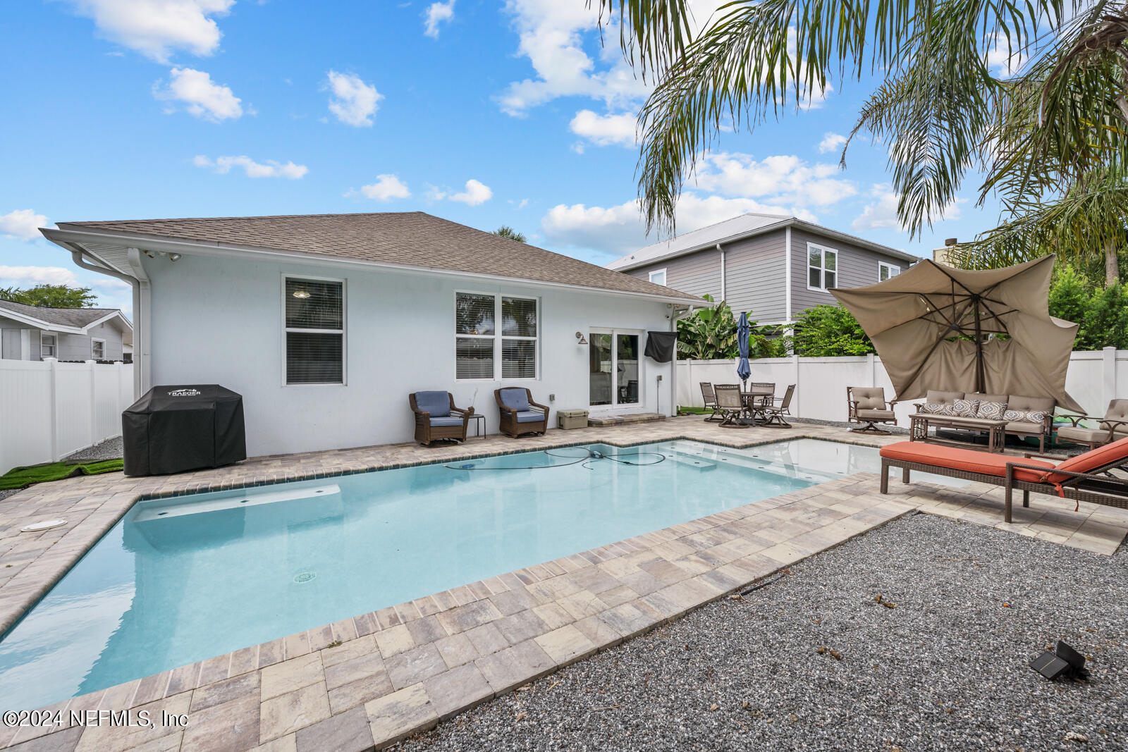 a view of a house with swimming pool and sitting area