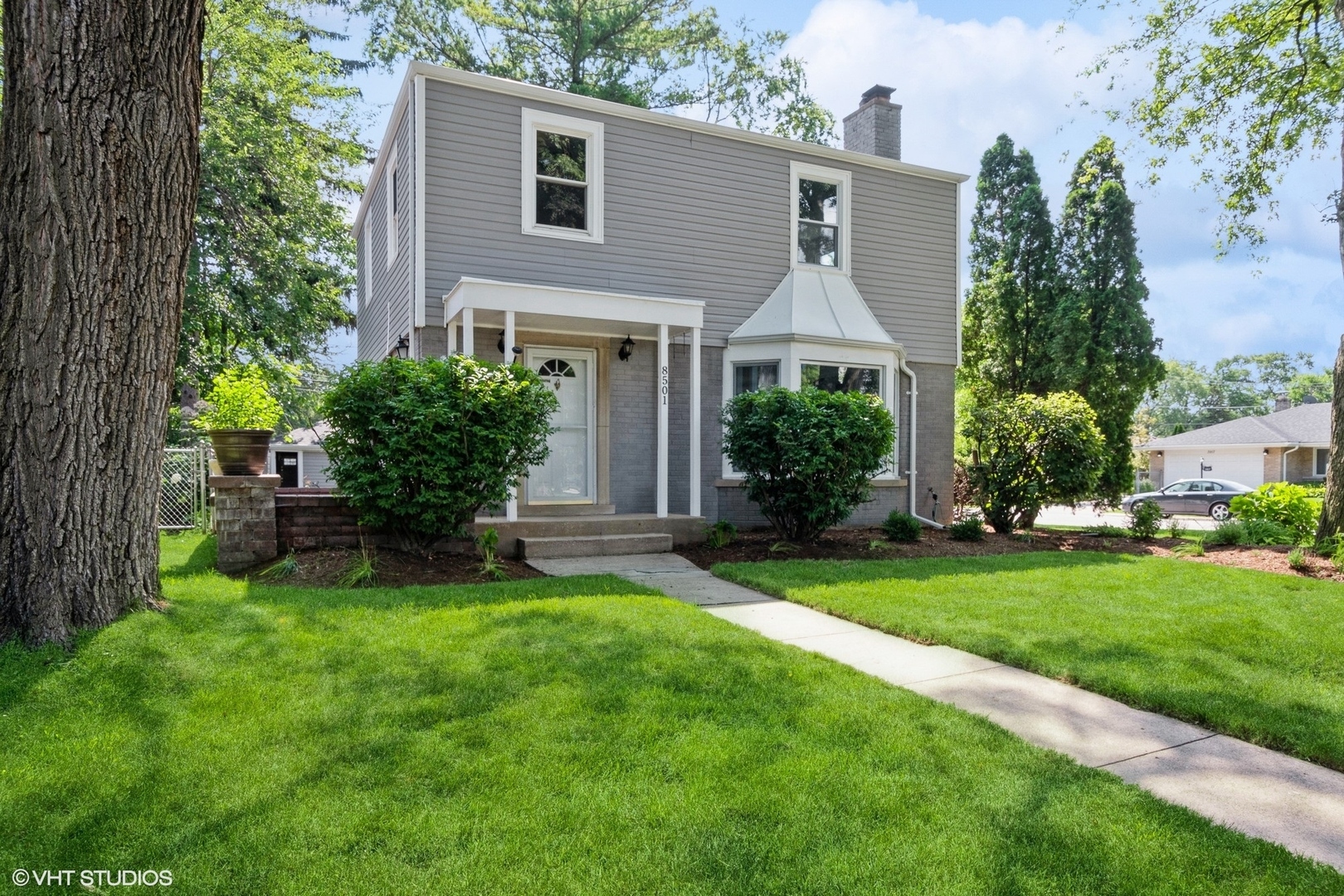 a front view of house with yard and green space