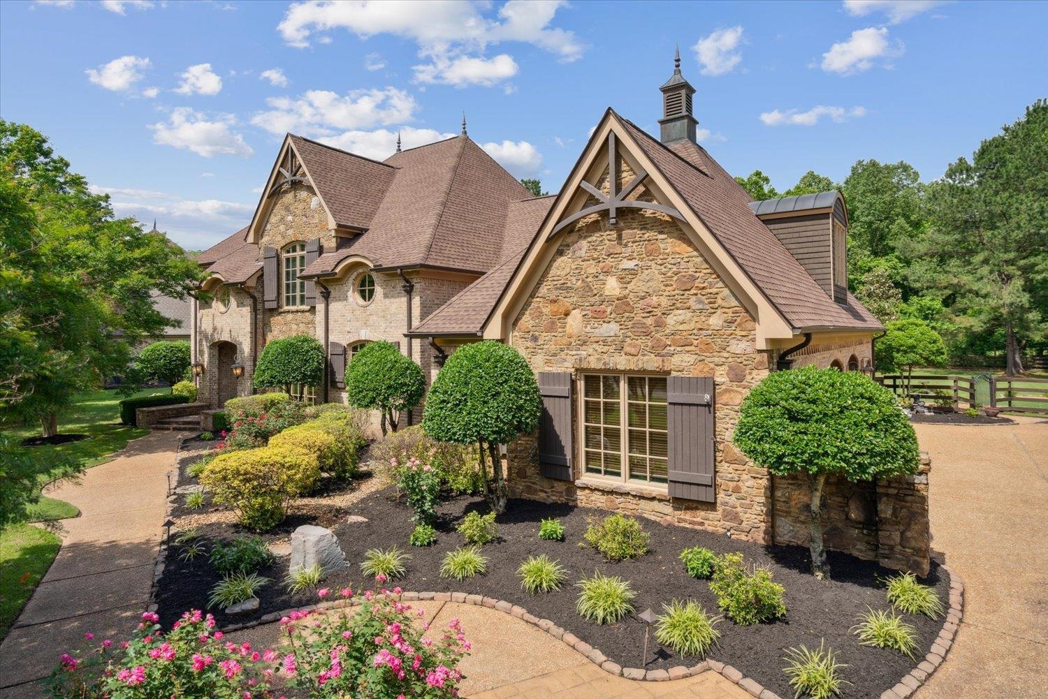 front view of house with a yard and potted plants