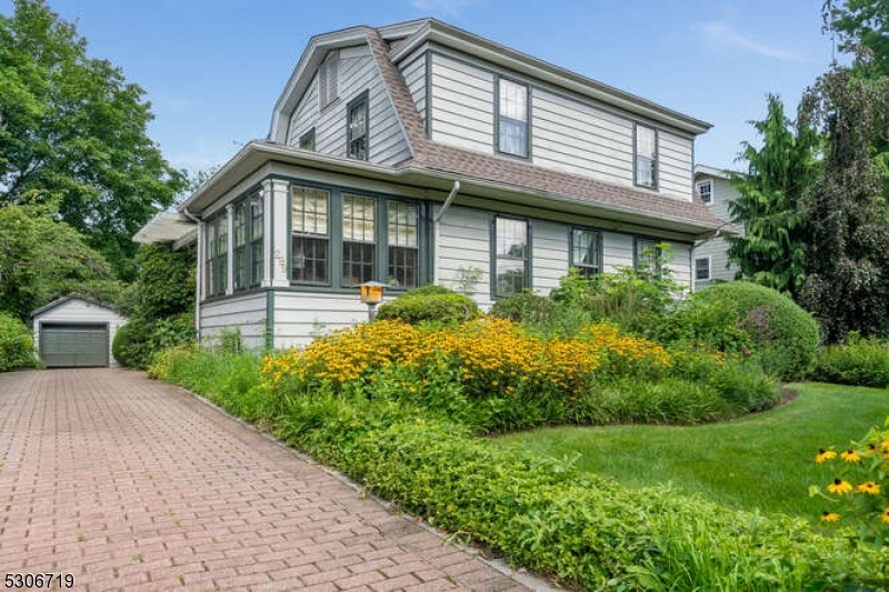 a front view of a house with garden