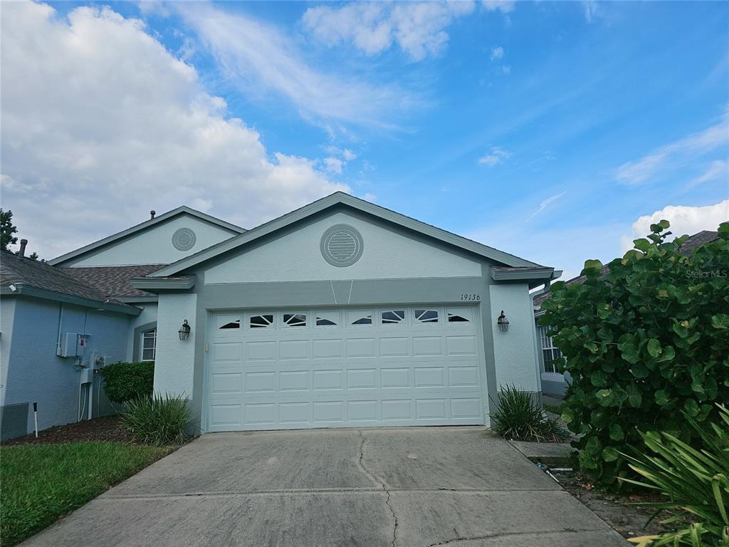 a front view of a house with garage