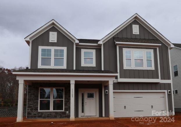 a front view of a house with garage