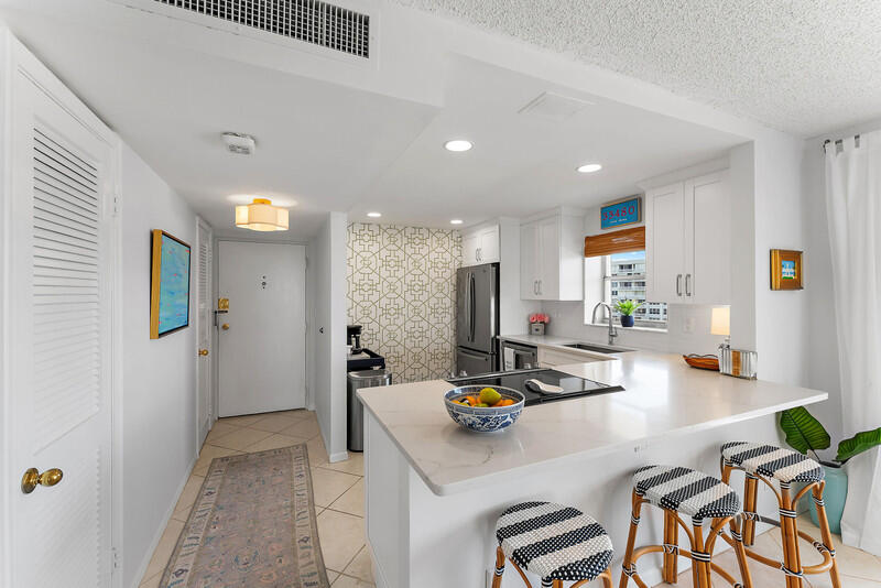 a kitchen with a sink a stove and chairs