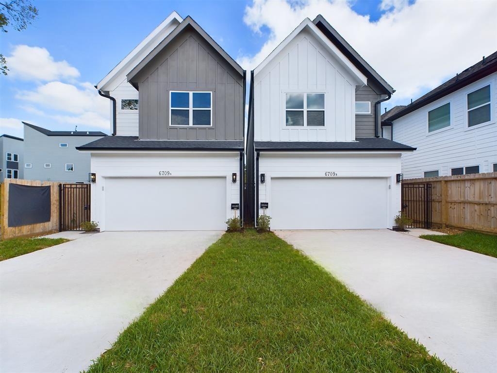 a front view of house with yard and garage