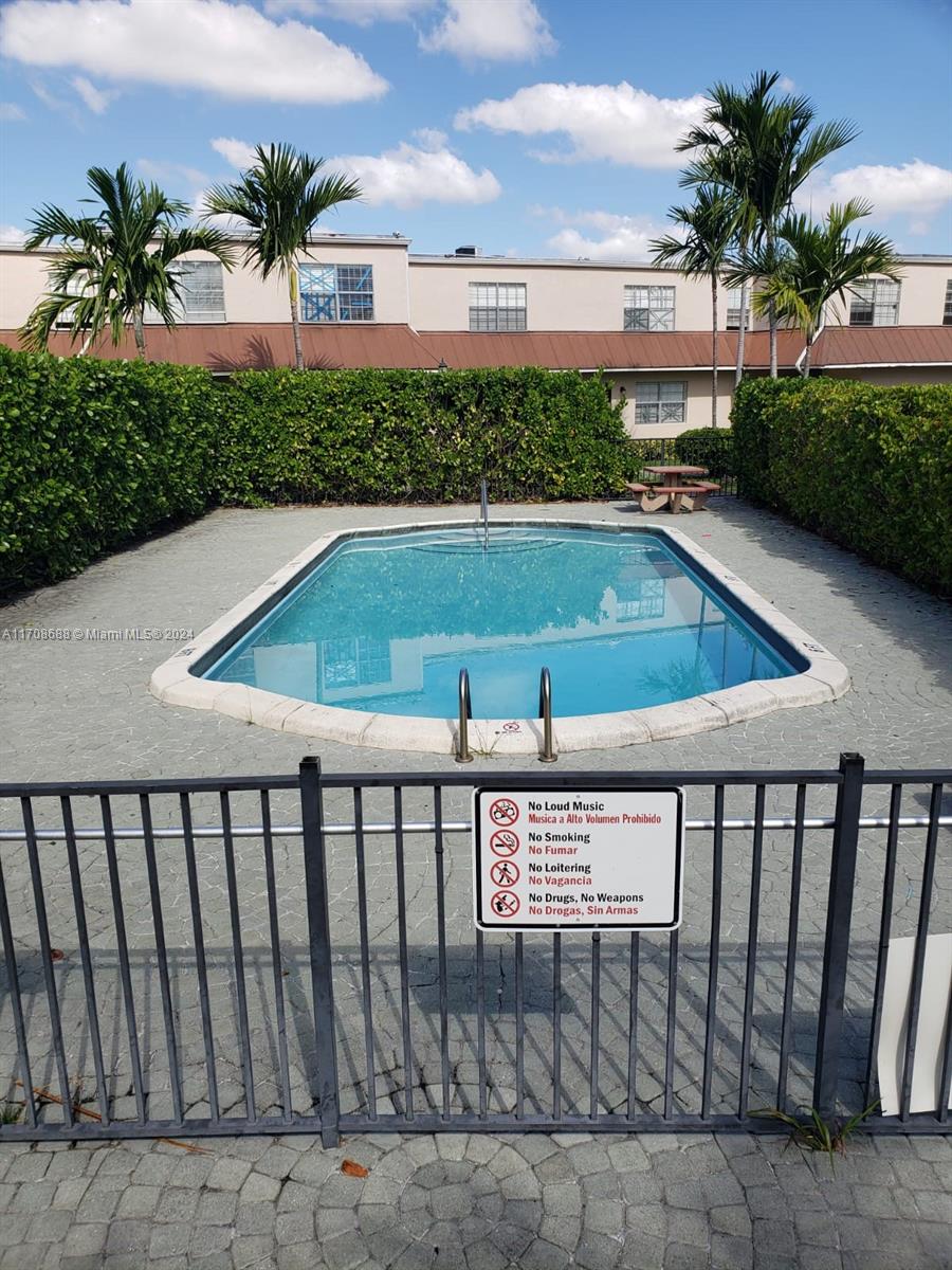 a view of swimming pool with outdoor seating