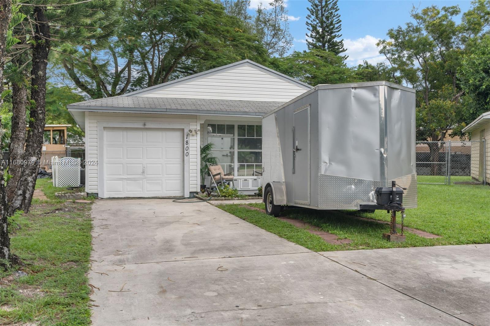 a front view of a house with a garden and yard