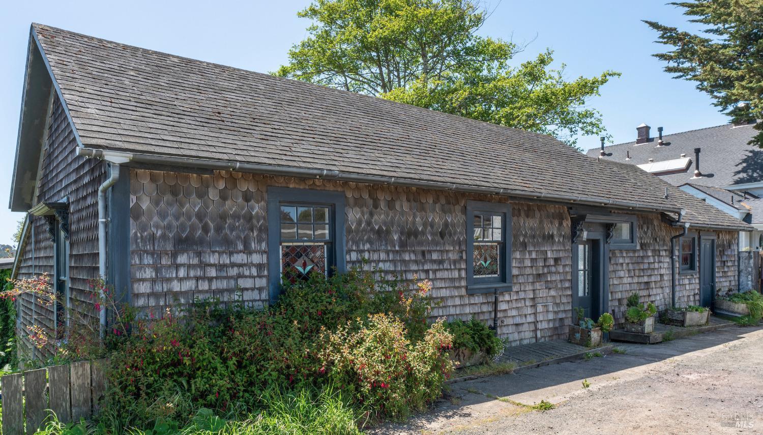 a front view of a house with a garden