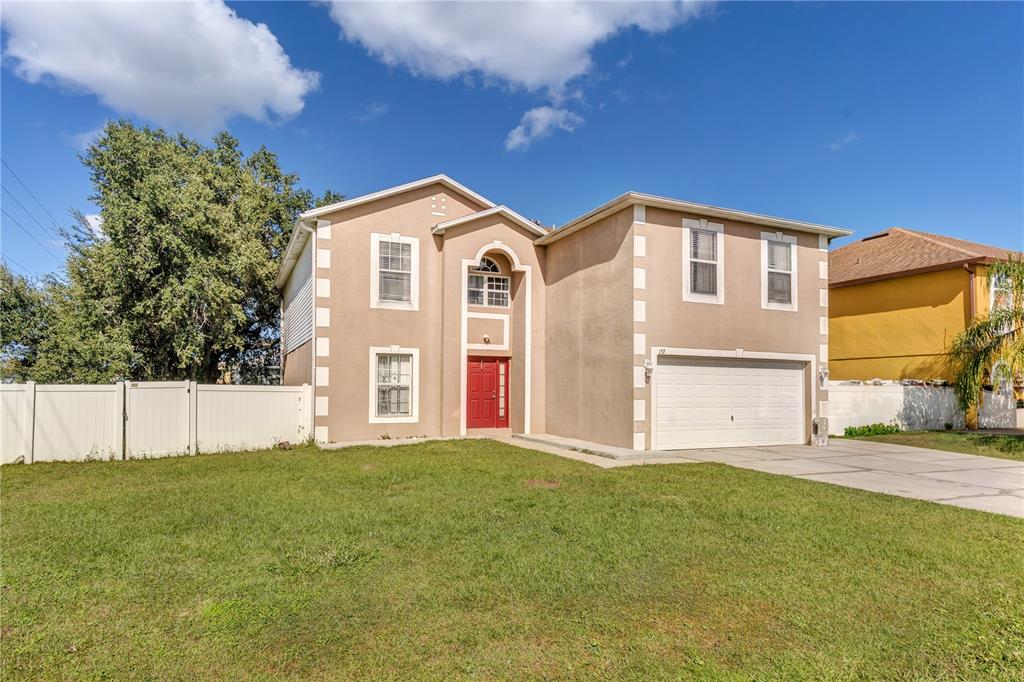 a front view of a house with a big yard