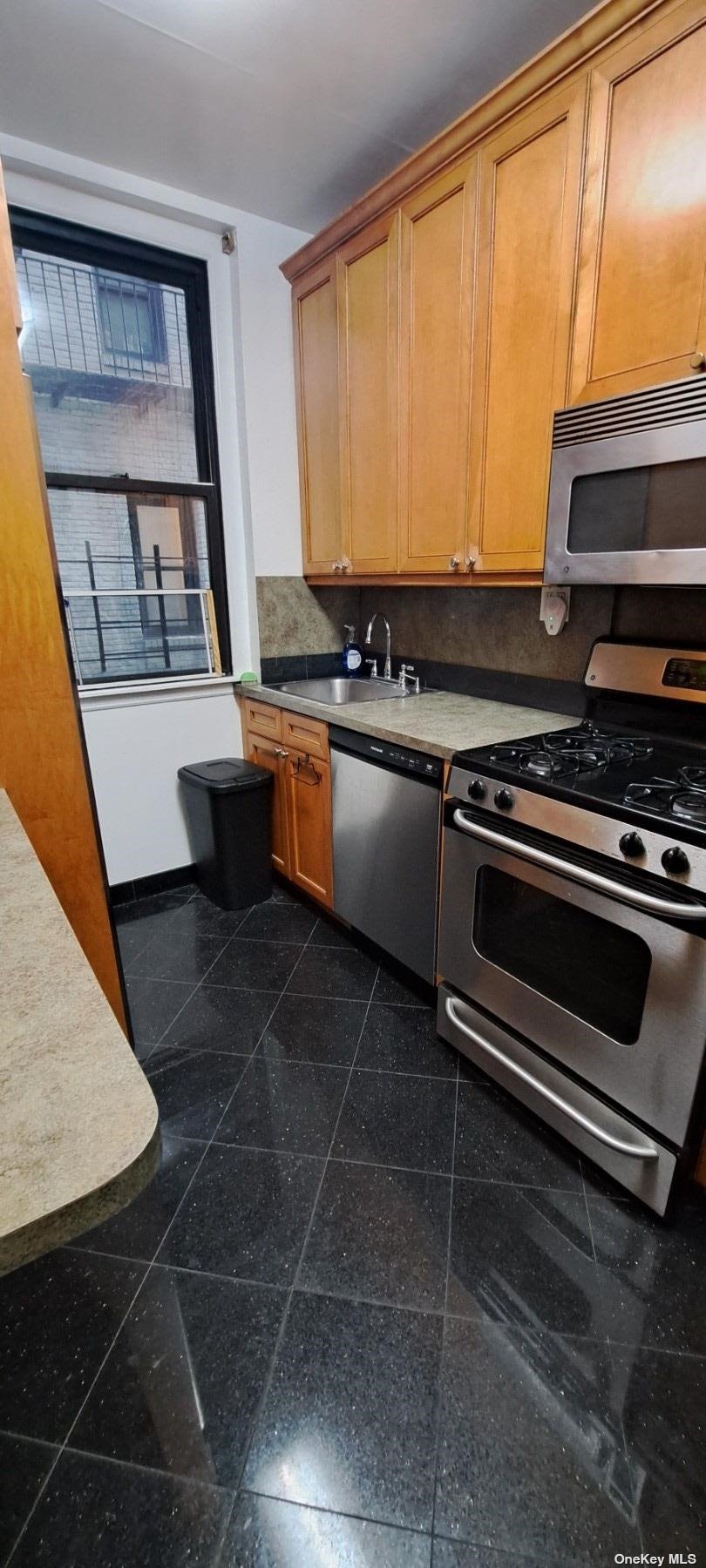 a kitchen with a stove a sink and a microwave