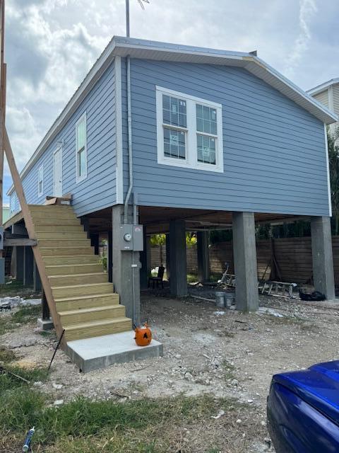 a front view of a house with stairs yard outdoor seating area