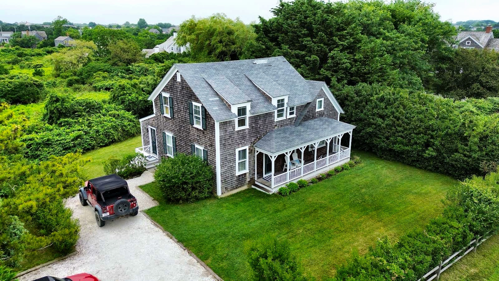 an aerial view of a house with a yard table and chairs