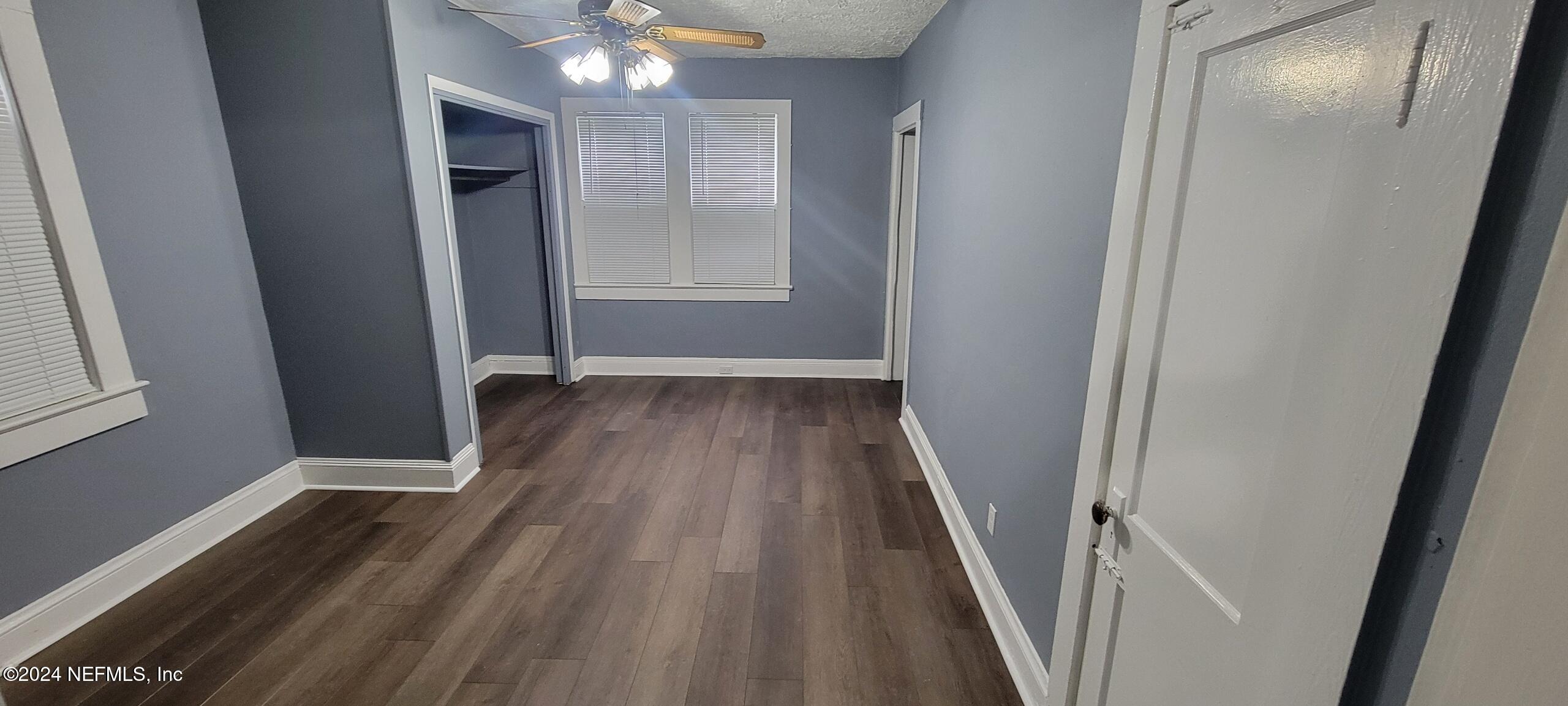 a view of hallway with wooden floor