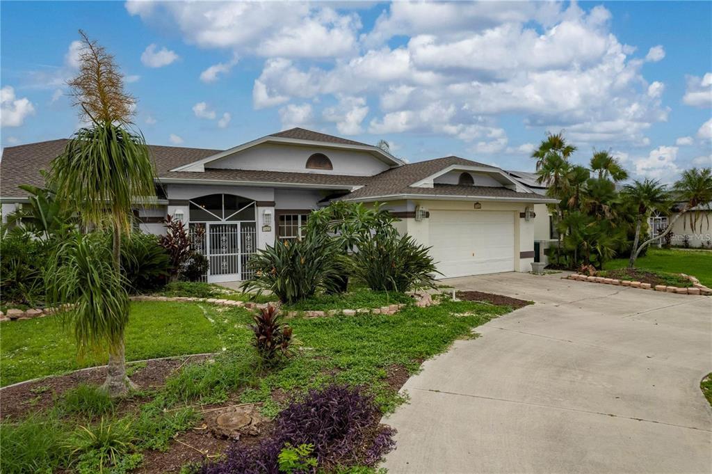 a front view of house with a garden