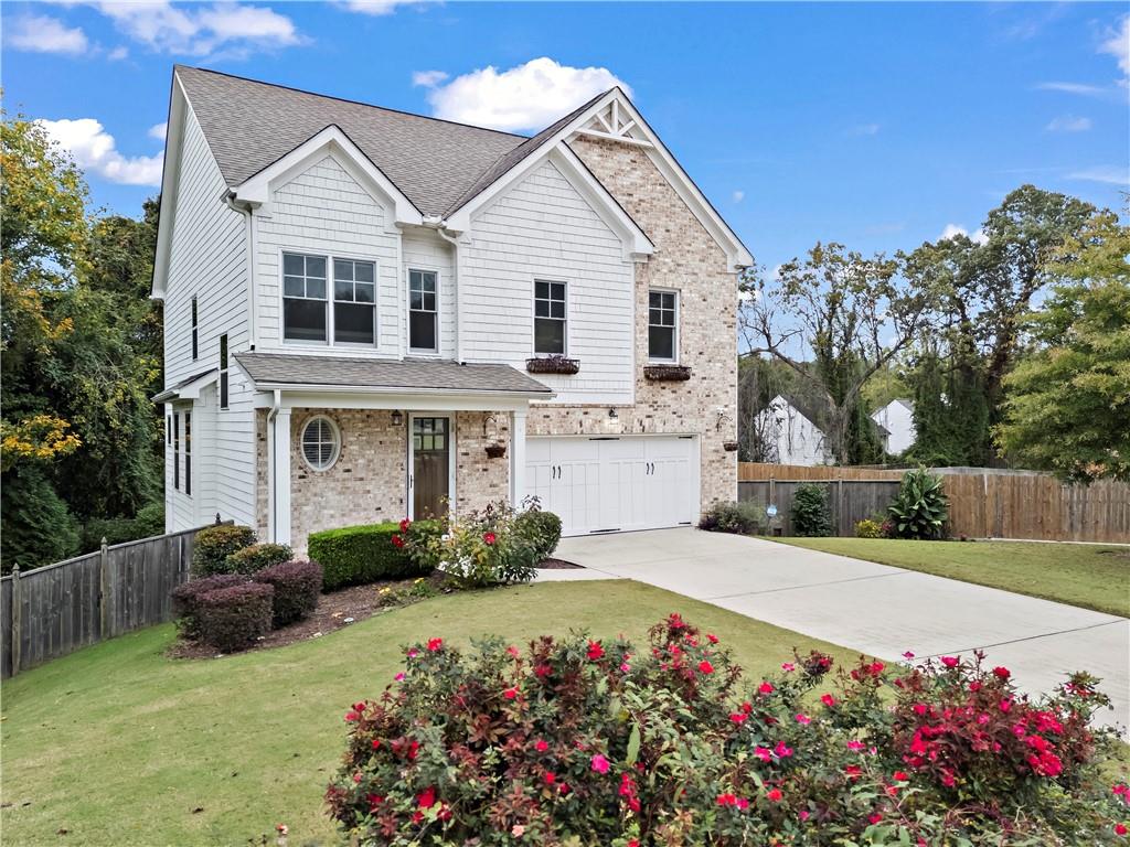 a front view of a house with a garden