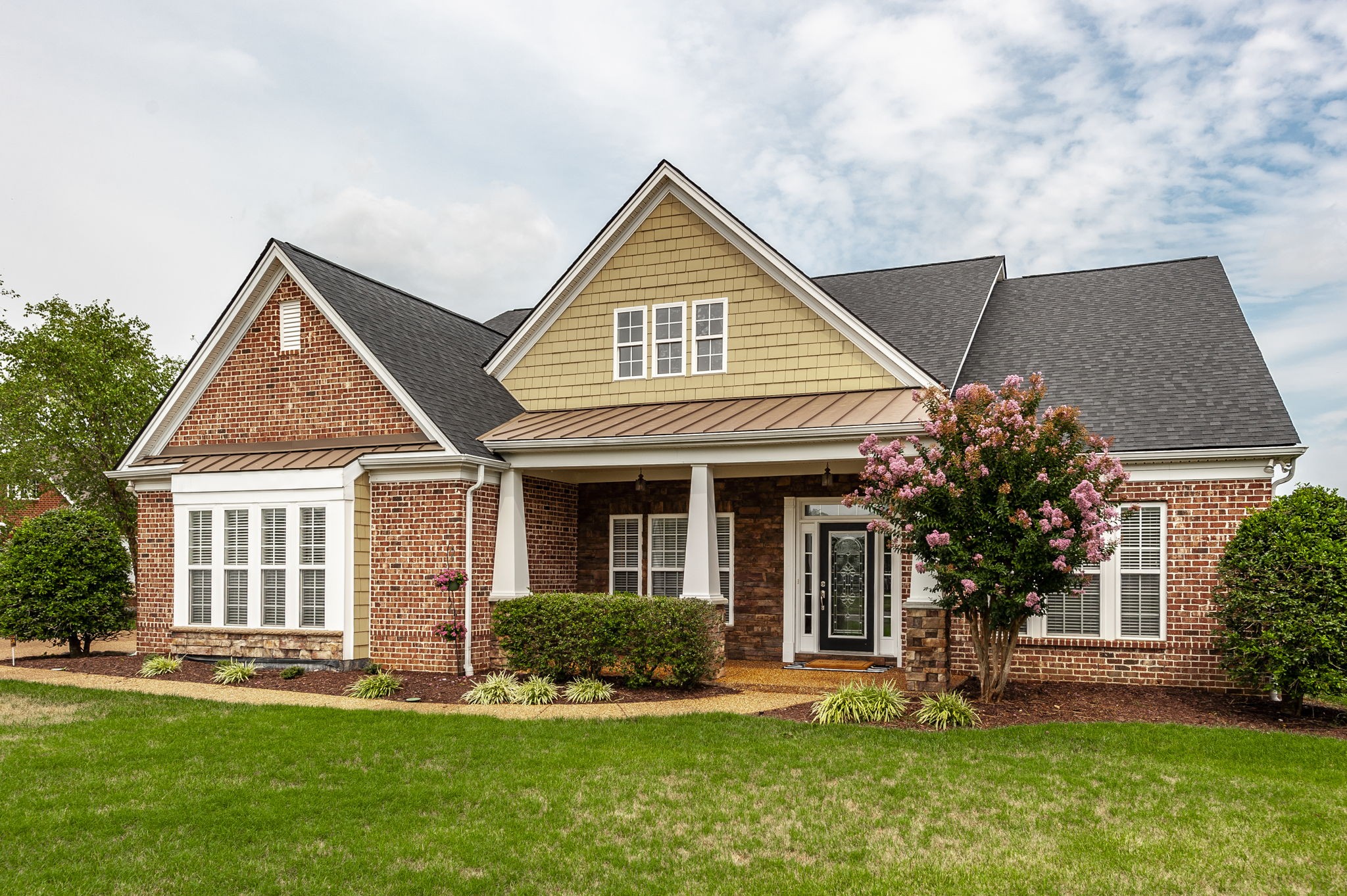 front view of a house with a yard