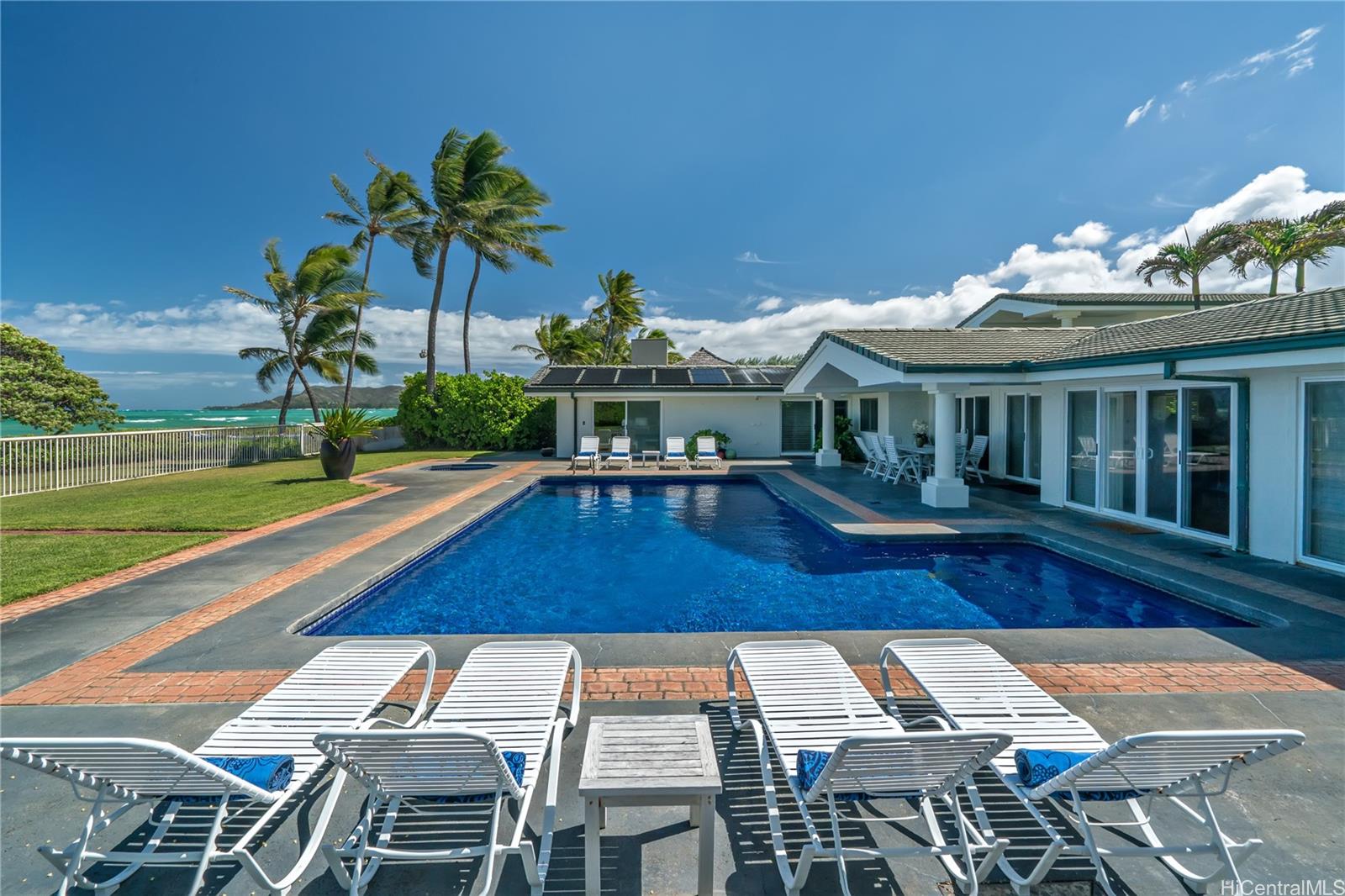 a view of a patio with swimming pool table and chairs