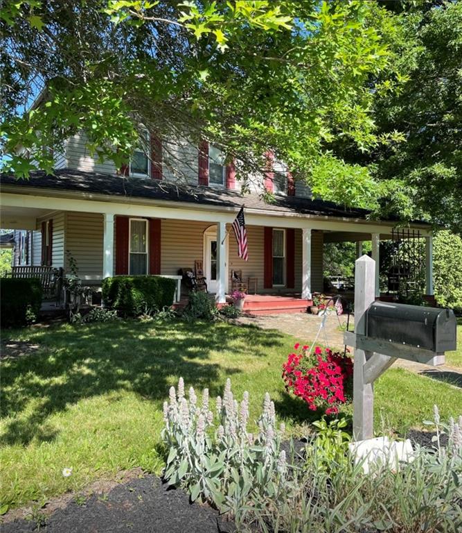 a front view of house with yard and outdoor seating