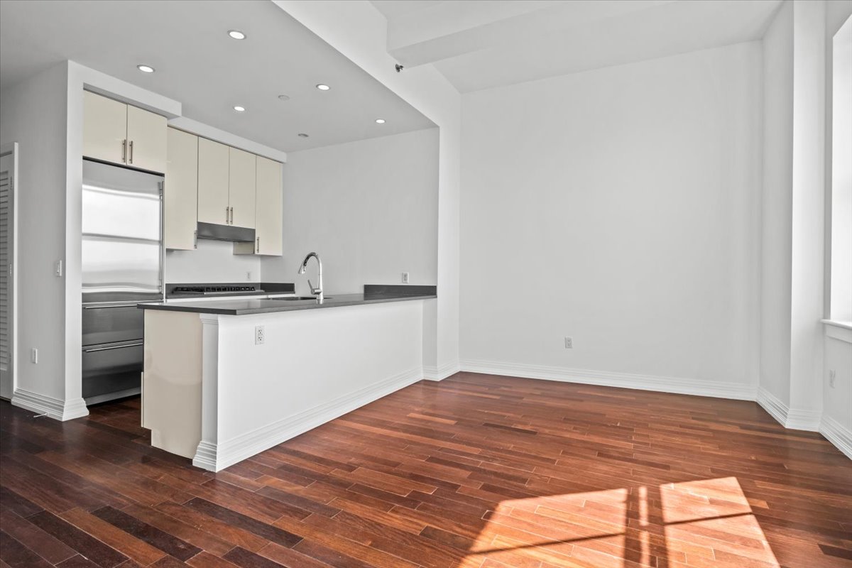 a kitchen with granite countertop white cabinets and white appliances