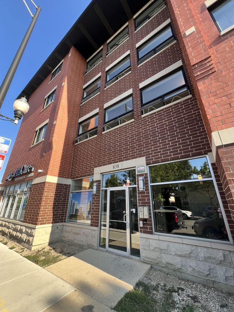 a view of building with car parked