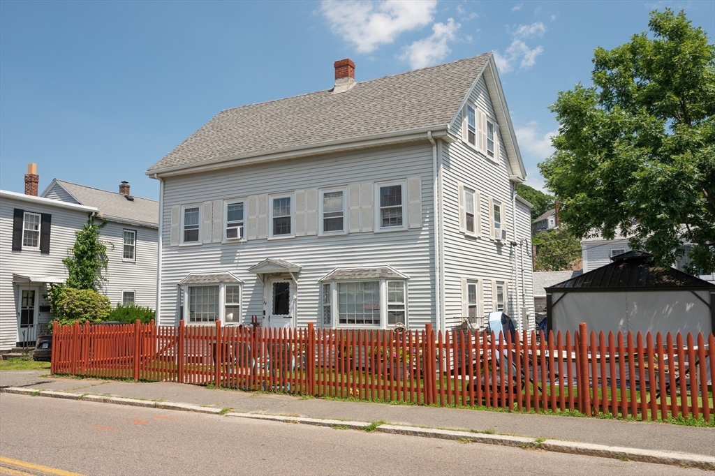 a front view of a house with a street